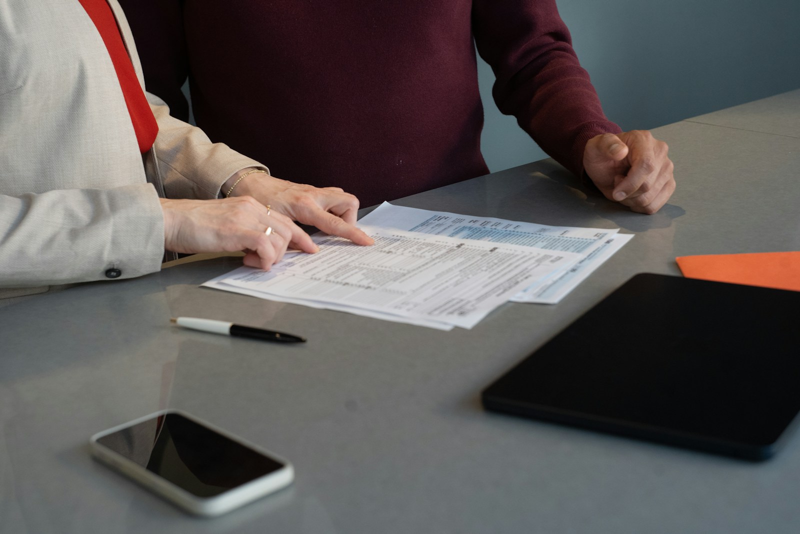 constituent meeting at a table with a folder of papers