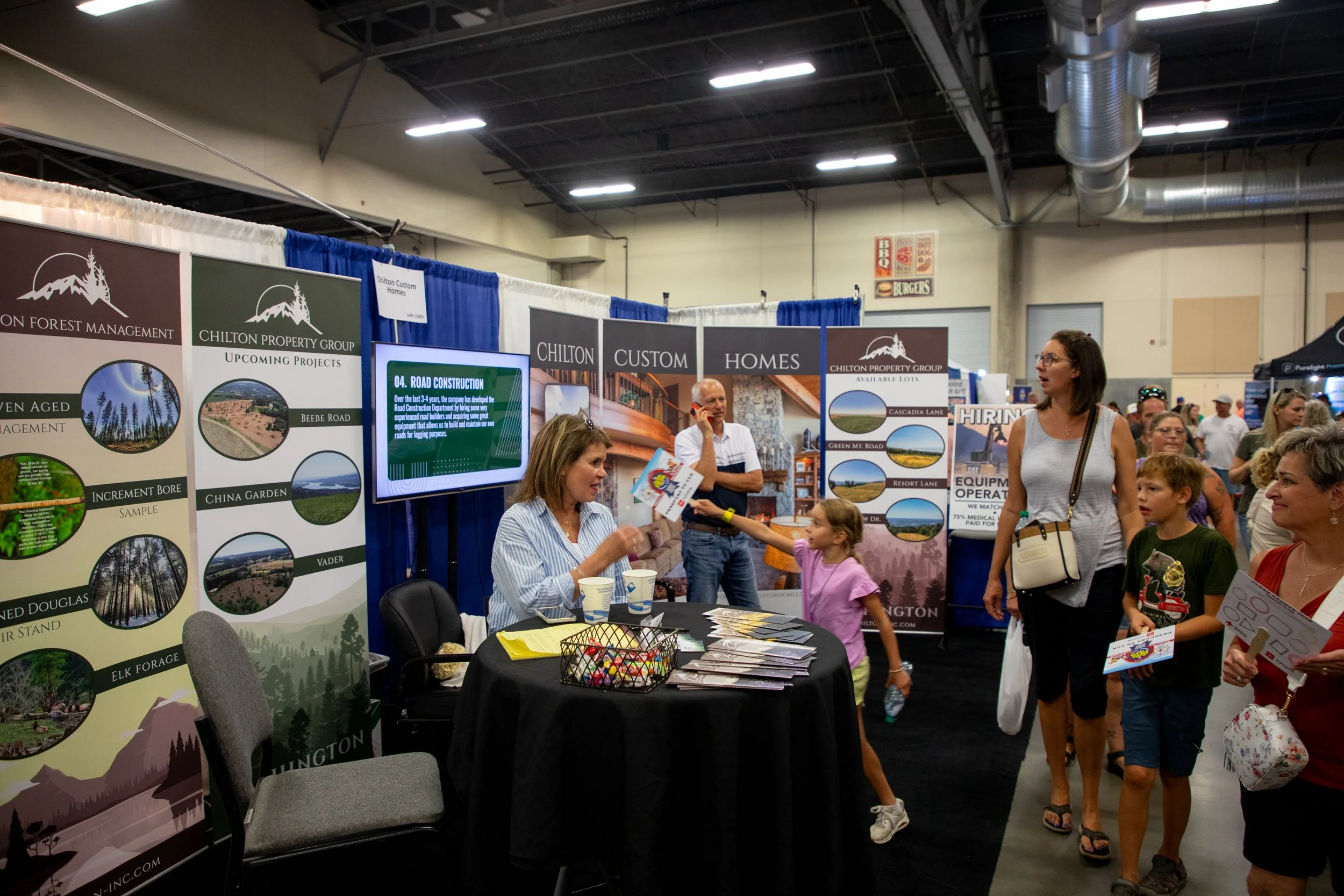 county fair booth with people talking
