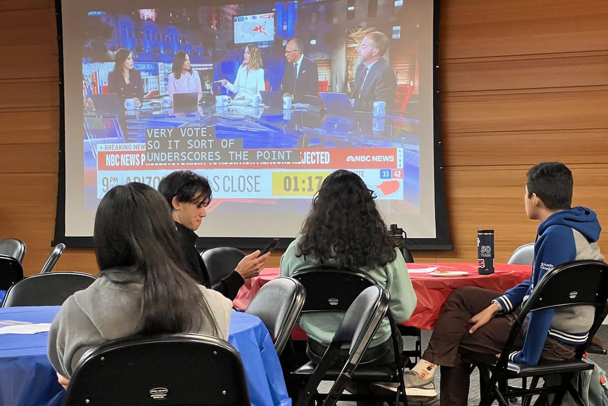 election night results shown on a screen at a gathering